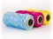 Rolls of thread with CMYK colors.