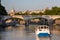Roma Italy, Boat on Tiber River with Bridge and Cityscape