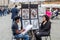 Roma, Italy - October 2015: A talented street artist draws a pencil on paper portrait of a woman sitting on a chair near the fount
