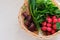 Romaine salad, radish, beetroot, garlic, arugula. Basket with various vegetables. Top view. Place for text.