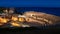 Roman amphitheater illuminated at night. Well-preserved monument in the old city of Tarraco. Inside it there is a Romanesque style