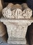 Roman antique pillar with flower decoration on top