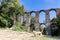 Roman aqueduct in an archaeological park, nature excursions in Italy, trekking and archeology. Tourism in Italy and nature trails