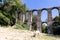 Roman aqueduct in an archaeological park, nature excursions in Italy, trekking and archeology. Tourism in Italy and nature trails