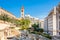 Roman baths ancient ruins site, modern buidings and Saint Louis Cathedral of the Capuchin Fathers Latin Catholic church in the