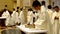 Roman Catholic priests taking communion during congregation mass