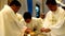 Roman Catholic priests taking communion during congregation mass