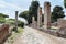 Roman empire street view with ruins and roman columns and typical cobblestone road at Ostia Antica - Rome