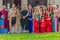 Roman gladiator in battle costume and a group of young Roman girls