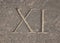 Roman numeral - eleven carved in stone