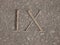 Roman numeral - nine carved in stone