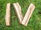 Roman numeral. Roman numerals made from oak. Old wood numbers. Old roman antique alphabet number on green grass background. Number