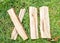 Roman numeral. Roman numerals made from oak. Old wood numbers. Old roman antique alphabet number on green grass background. Number