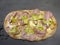 Roman pinsa, variant of the classic pizza topped with mortadella, stracciatella and lamb\\\'s lettuce and pistachios