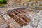 Roman ruins of Conimbriga. Hypocaust structure used to heat the water of the Caldarium room in the Roman Baths of the Wall.