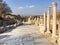 Roman stone pillars and statue ruins on road side in ephesus Arc