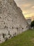 The Roman walls of Portchester castle and the medieval keep under a warm September sunset