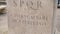 Roman writing and bas-reliefs imperial era archeology italy. Stock. SPQR inscription on the wall