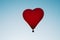The romance of flying in a balloon in the shape of a red heart