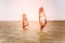 Romance in the sea couple man and woman together sailing on a windsurfing board while on vacation in south