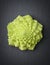 Romanesco broccoli on a stone slab.