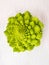 Romanesco cabbage head on white wooden