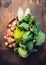 Romanesco with fresh vegetables in dish on rustic wooden background