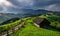 Romanian hillside and village in summer time , mountain landscape of Transylvania in Romania