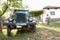 the romanian jeep - in a rural fund of Cerna Sat, on background a peasant woman in front of her farmhouse. Shot in 2016