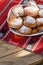 Romanian mini doughnuts on a plate on red traditional cloth