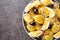 Romanian oriental potato salad with onions, olives and boiled eggs close-up on a plate. horizontal top view