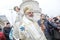 Romanian Orthodox Patriarch Daniel sprinkles holy water over believers at the end of the Epiphany mass, outside the patriarchal