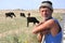 Romanian shepherd with cows in the countryside 