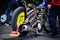 A romanian team mechanic prepares one of the riders motorbikes ahead of the first heat of their 2014 National Championship campai