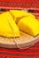 Romanian traditional dish polenta mamaliga on wooden plate sliced with a string