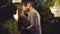 Romantic adult boyfriend and girlfriend kissing on summer night outdoors. Side view portrait of happy loving couple
