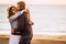 Romantic adult couple in love hug and have fun together with joyful. Concept of relationship man and woman embracing outdoor with