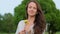 Romantic adult woman with small dandelions in countryside