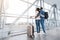 Romantic african american couple standing near window at airport and hugging