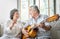 Romantic Asian senior Couple singing and playing acoustic guitar together