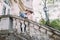 Romantic attractive newlywed couple in love posing on ancient stairs at the old austrian palace