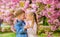 Romantic babies. Tender love feelings. Couple kids on flowers of sakura tree background. Little girl enjoy spring