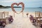 Romantic beachside vows Roses, heart decor in a small, charming wedding