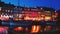 Romantic beautiful evening view of the waterfront Nyhavn in Copenhagen. The reflection of a bright light houses and restaurants