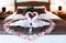 Romantic Bedroom Interior, Kissing Swan Origami Towels and sprinkled fresh Pink White Rose Flower Petals decoration on bed for