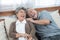 Romantic with big smile and laughing of senior elder asian grandmother and grandfather sit on couch sofa in home,retirement elder