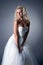 Romantic blonde posing in lush wedding dress