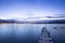 Romantic blue sunset with a jetty over a lake