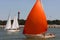 The romantic boat with scarlet sail in port.