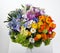 Romantic bouquet of Ranunculus, lilac, Crocus, calendula, Orchid and forget-me-nots in vase on a light background. gift for women